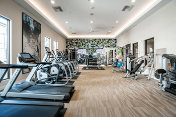 24-Hour fitness center with free weights, cardio equipment and weight machines